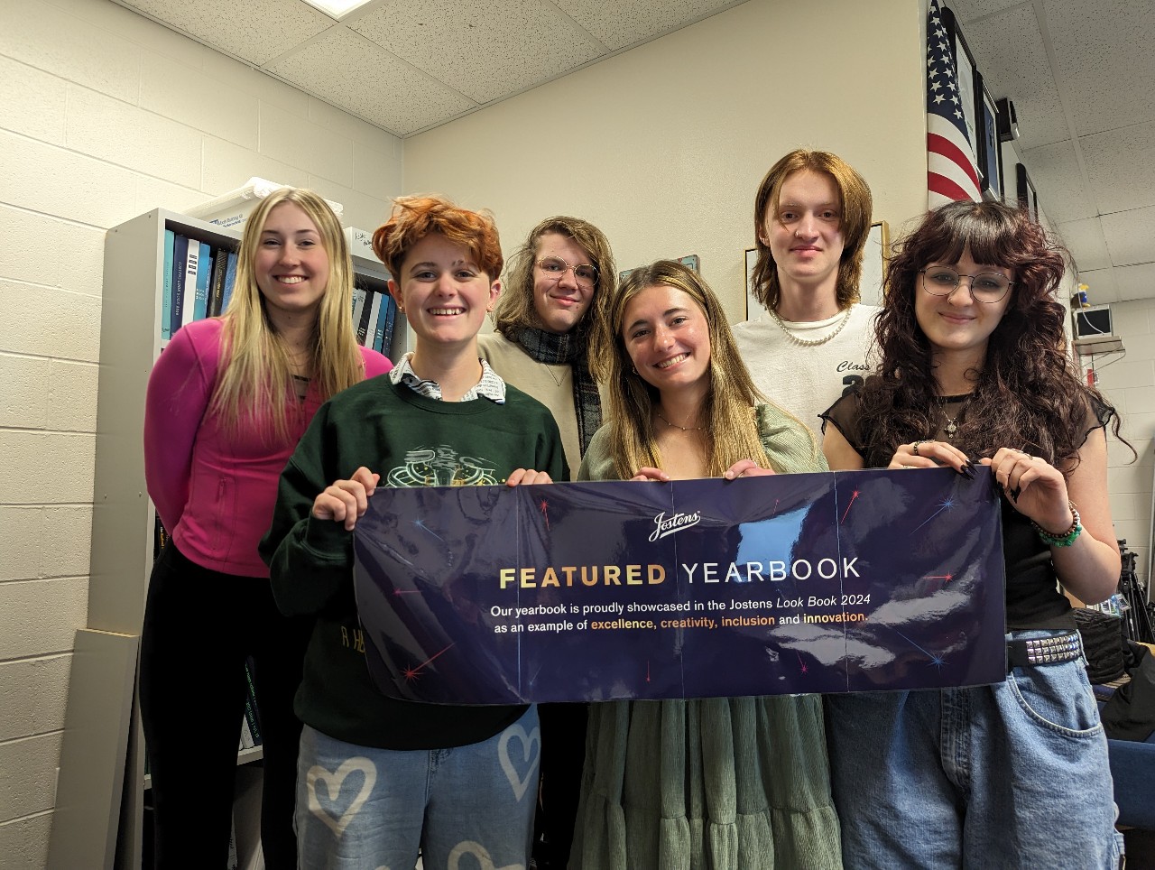 Students holding banner that says, "Featured Yearbook"